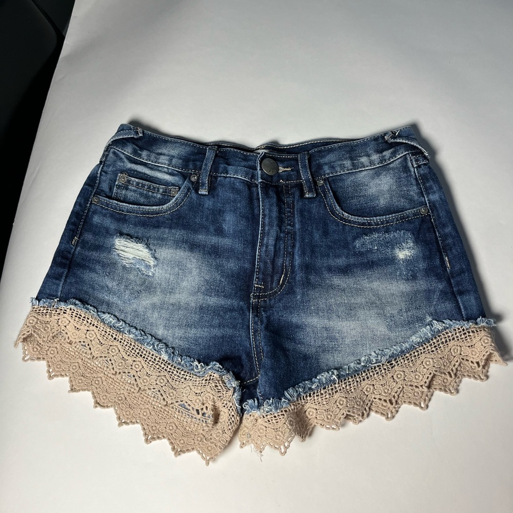 Women’s free people lace crocheted trim denim shorts.  Rips in front & back.